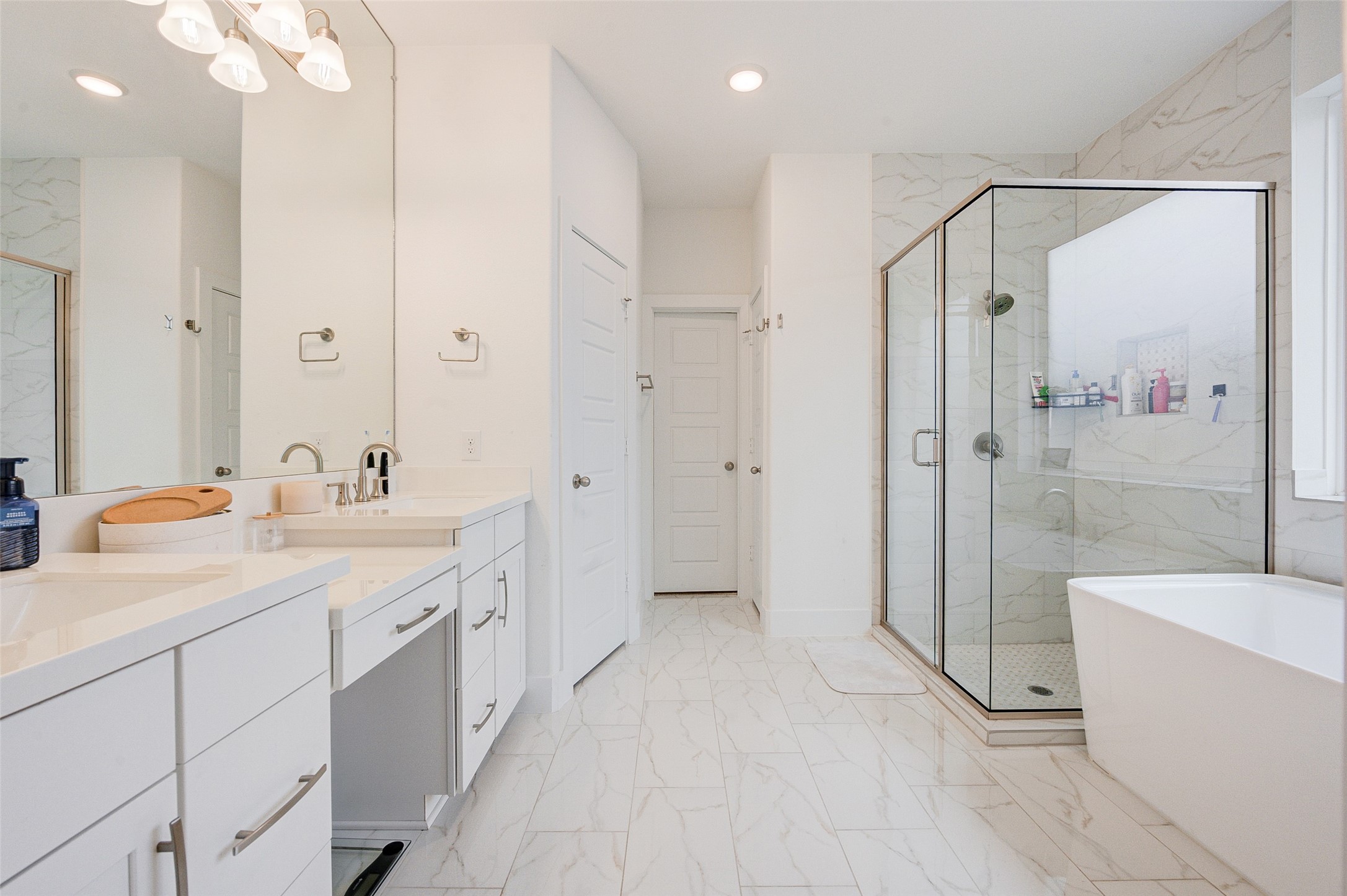 4606 Wax Myrtle Court Fulshear, TX 77441 - Photo 23 of 36 a bathroom with a double vanity sink toilet mirror and shower