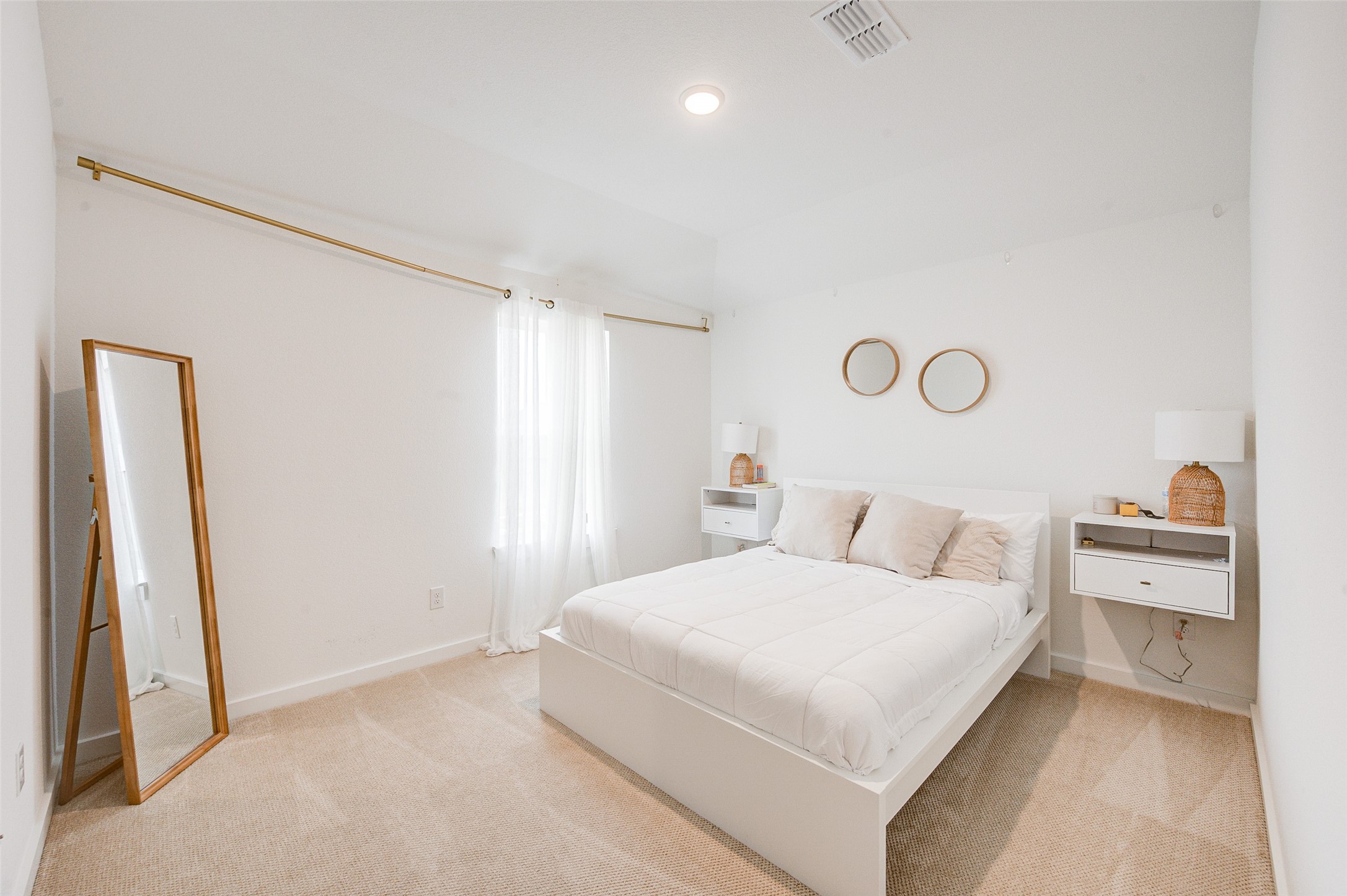 4606 Wax Myrtle Court Fulshear, TX 77441 - Photo 30 of 36 a bedroom with a bed and a large mirror