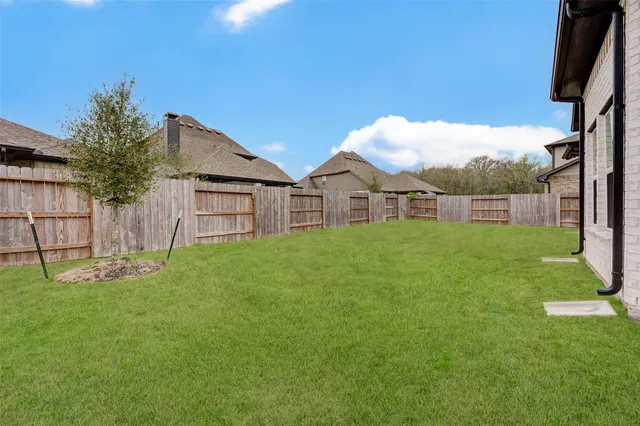 a view of a house with a yard and a garden