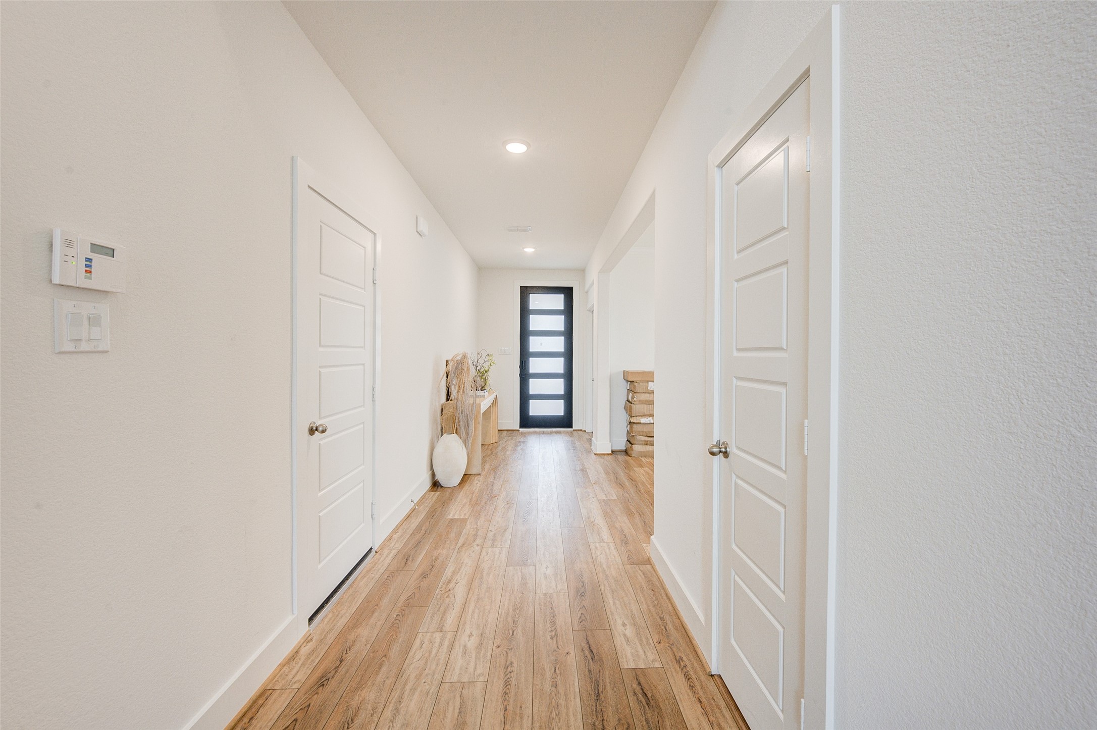 4606 Wax Myrtle Court Fulshear, TX 77441 - Photo 8 of 36 a view of a hallway with wooden floor