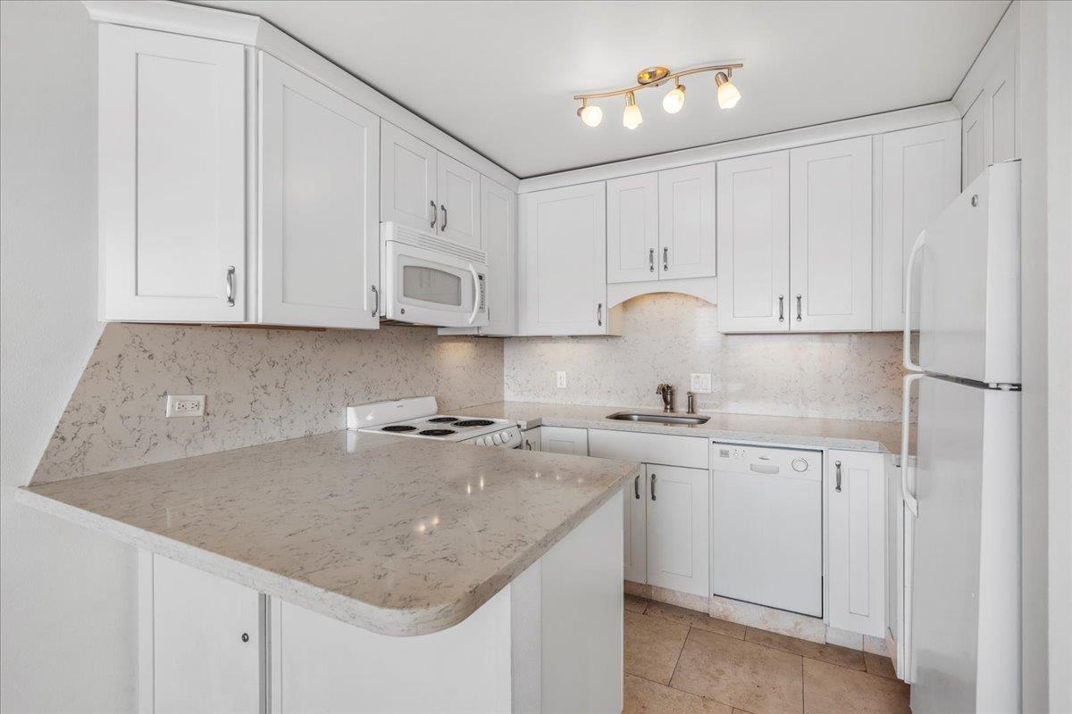 1403 Front Street, Unit 309 Lahaina, HI 96761 - Photo 9 of 33 a kitchen with stainless steel appliances granite countertop a sink stove and cabinets