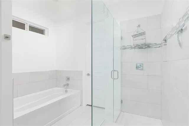 a bathroom with a bathtub and shower