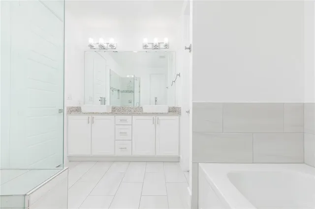 a bathroom with a bathtub and shower