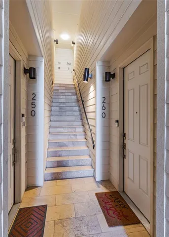 a view of entryway with a rug and wooden floor