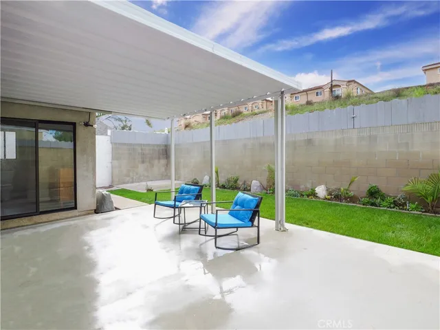 a view of a patio with a table and chairs