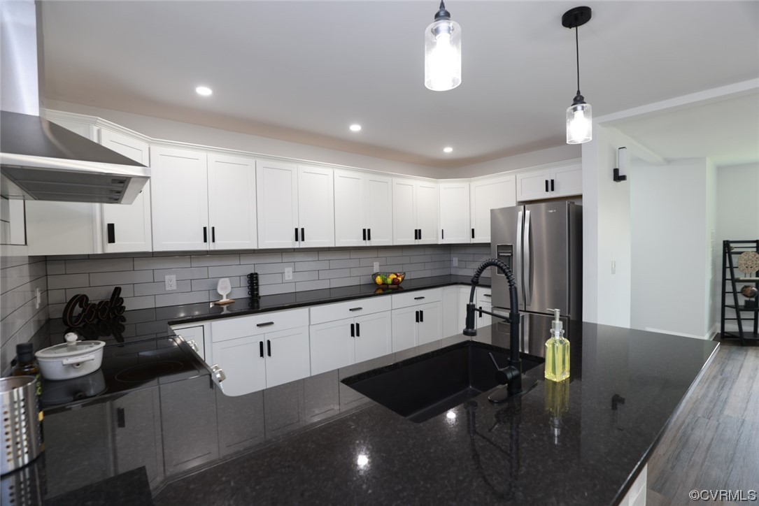 6830 Strathmore Road Richmond, VA 23237 - Photo 17 of 47 a kitchen with stainless steel appliances granite countertop a sink refrigerator and cabinets