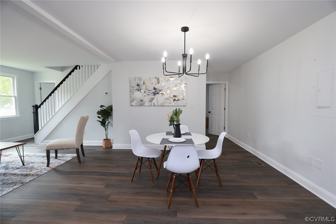 6830 Strathmore Road Richmond, VA 23237 - Photo 19 of 47 a view of a dining room with furniture wooden floor and chandelier