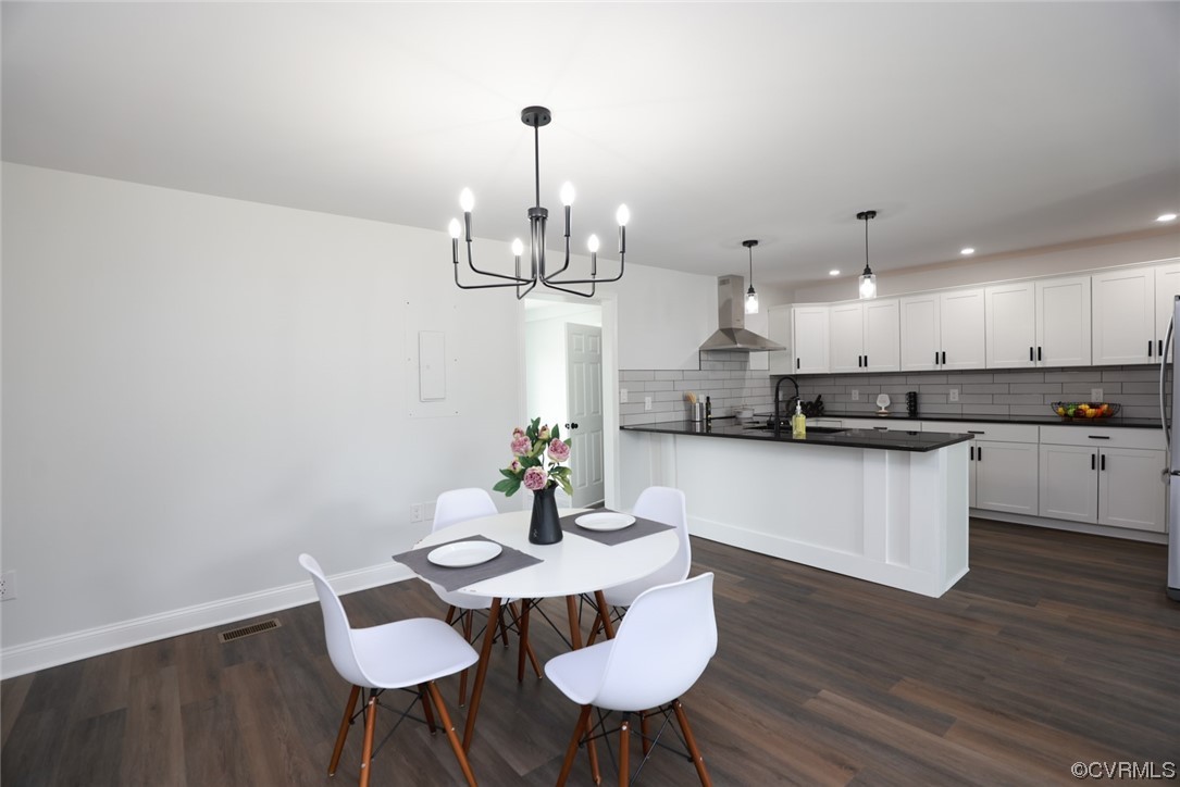 6830 Strathmore Road Richmond, VA 23237 - Photo 20 of 47 a kitchen with a dining table chairs and wooden floor