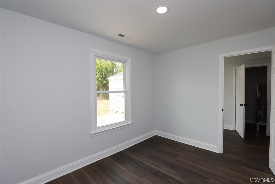 6830 Strathmore Road Richmond, VA 23237 - Photo 22 of 47 an empty room with wooden floor and windows