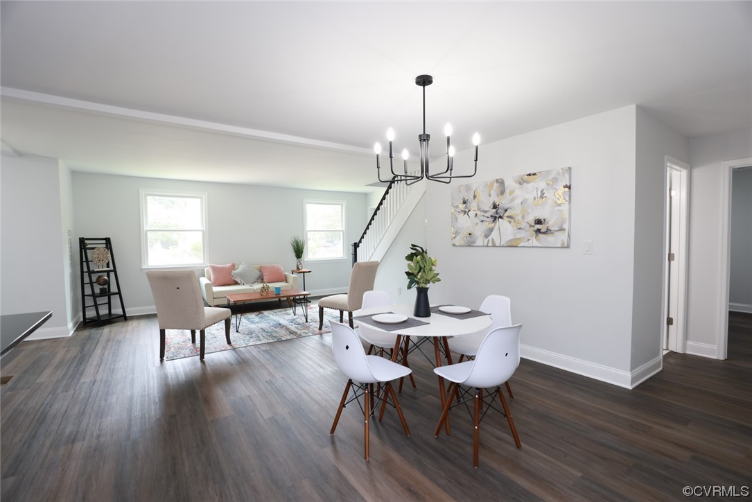 6830 Strathmore Road Richmond, VA 23237 - Photo 26 of 47 a view of a dining room with furniture wooden floor and chandelier