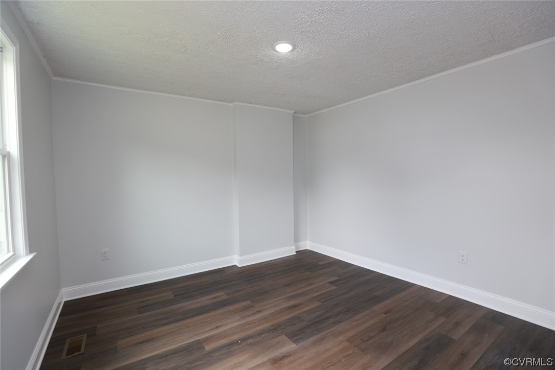 6830 Strathmore Road Richmond, VA 23237 - Photo 27 of 47 a view of an empty room with wooden floor and a window