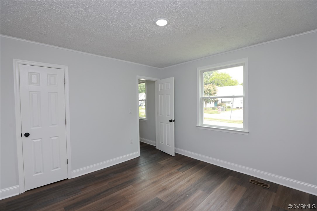 6830 Strathmore Road Richmond, VA 23237 - Photo 28 of 47 a view of an empty room with wooden floor and a window