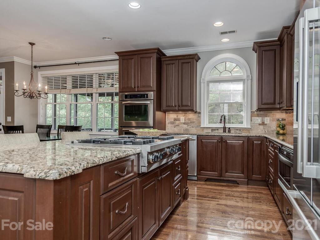3115 Planters Ridge Road Charlotte, NC 28270 - Photo 14 of 44 a kitchen with stainless steel appliances granite countertop a stove a sink and a microwave