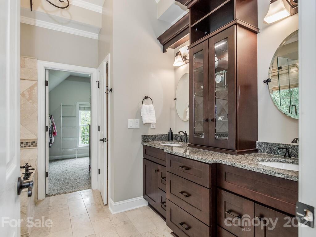3115 Planters Ridge Road Charlotte, NC 28270 - Photo 29 of 44 a bathroom with a granite countertop sink mirror and a shower