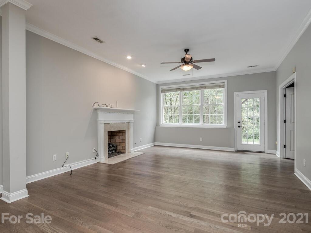 3115 Planters Ridge Road Charlotte, NC 28270 - Photo 36 of 44 an empty room with wooden floor fireplace and windows