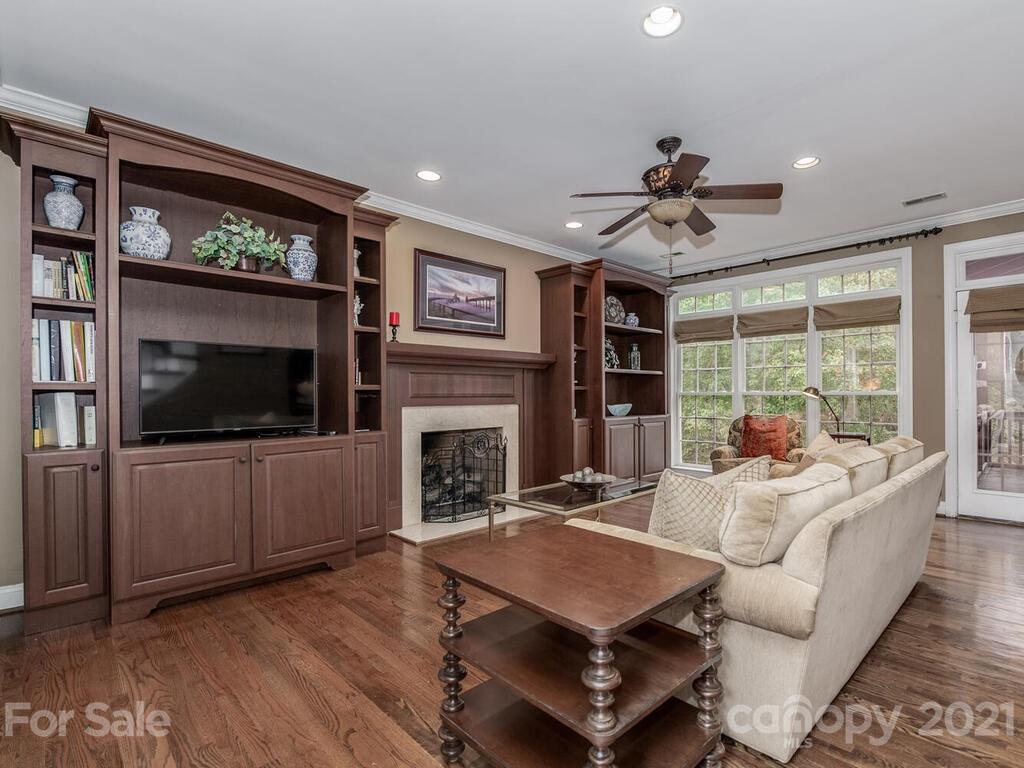 3115 Planters Ridge Road Charlotte, NC 28270 - Photo 8 of 44 a living room with furniture a flat screen tv and a fireplace