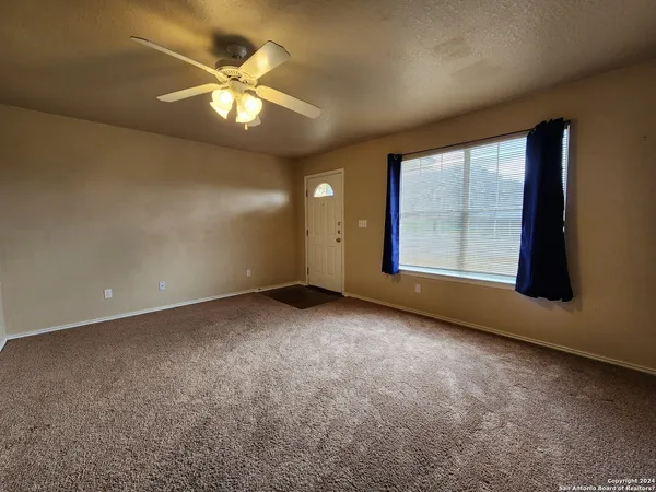 an empty room with a empty space and a ceiling fan