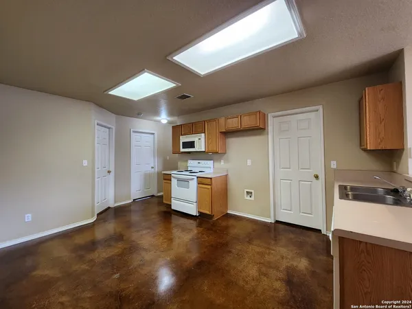 a large kitchen with cabinets and stainless steel appliances
