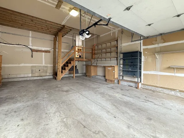 a view of empty room with wooden floor and windows