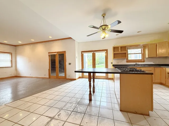 a view of a kitchen with an empty space and window