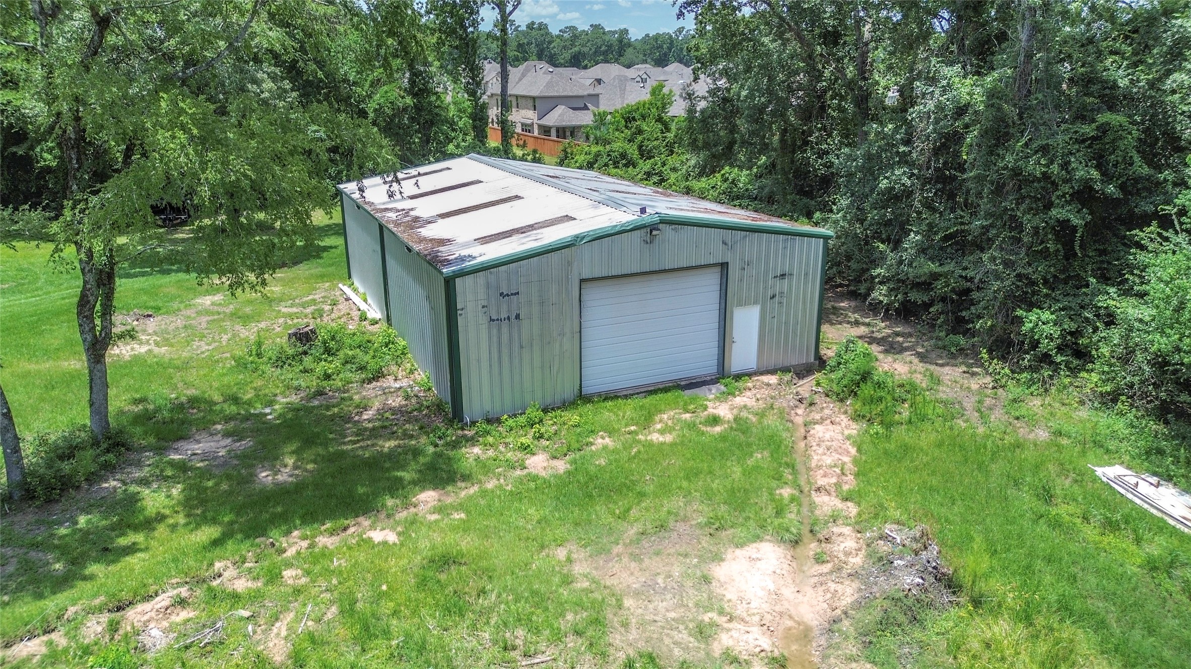 8330 Standard Road Magnolia, TX 77354 - Photo 7 of 13 a backyard of a house with a garden and deck