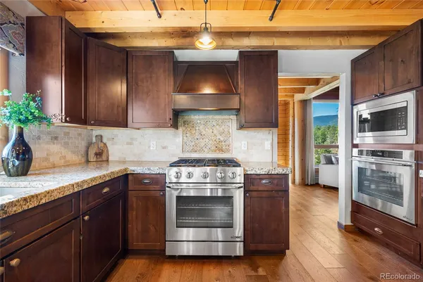 a kitchen with a sink a refrigerator and wooden cabinets