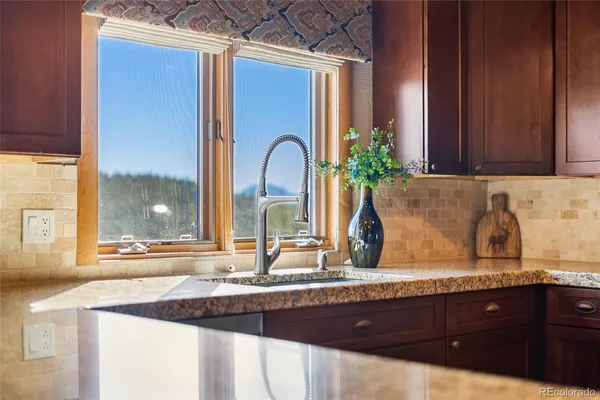 a kitchen with a refrigerator and a wooden floor