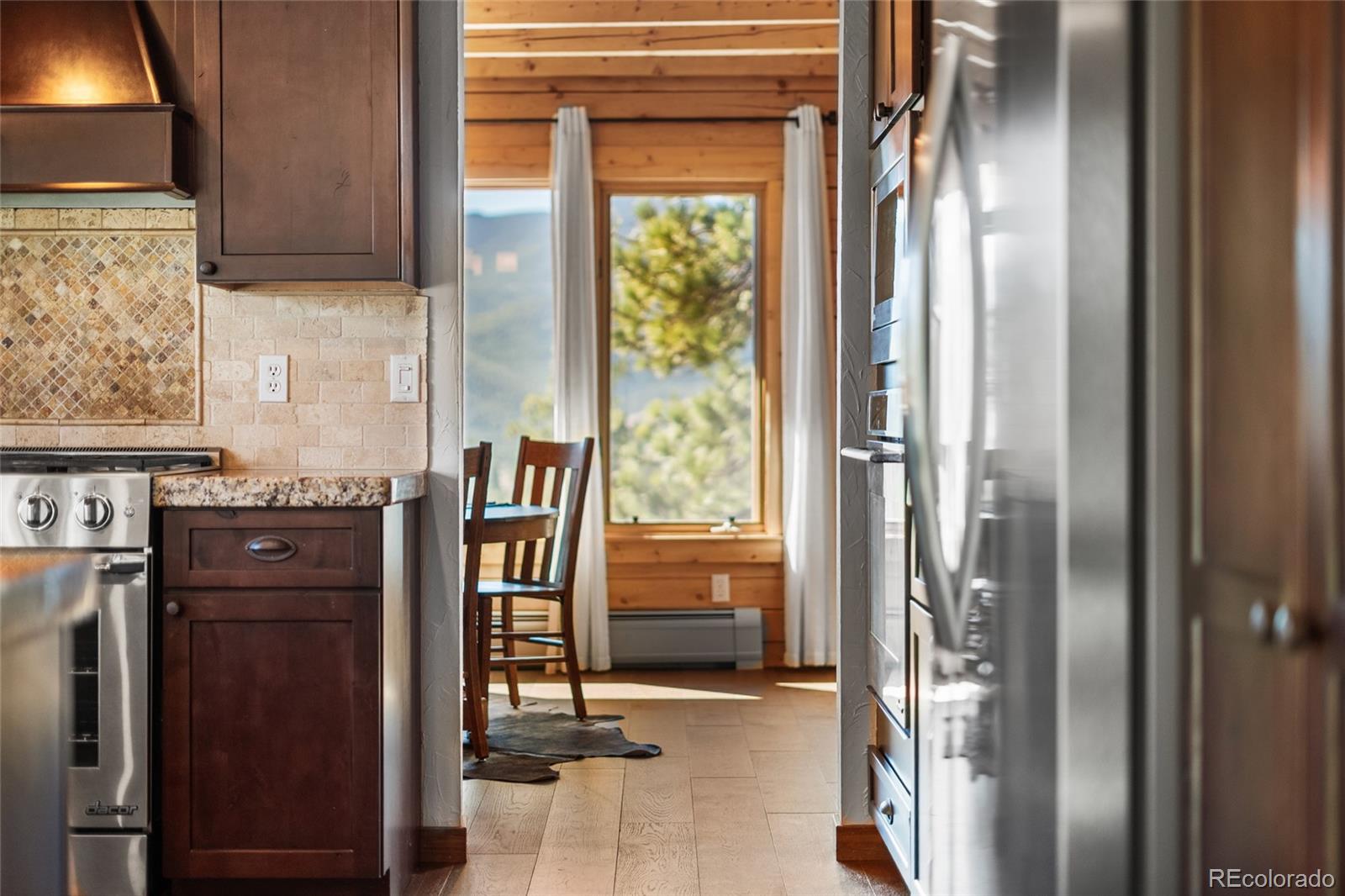 685 Jesse Lane Bailey, CO 80421 - Photo 14 of 50 a kitchen with a refrigerator and a wooden floor