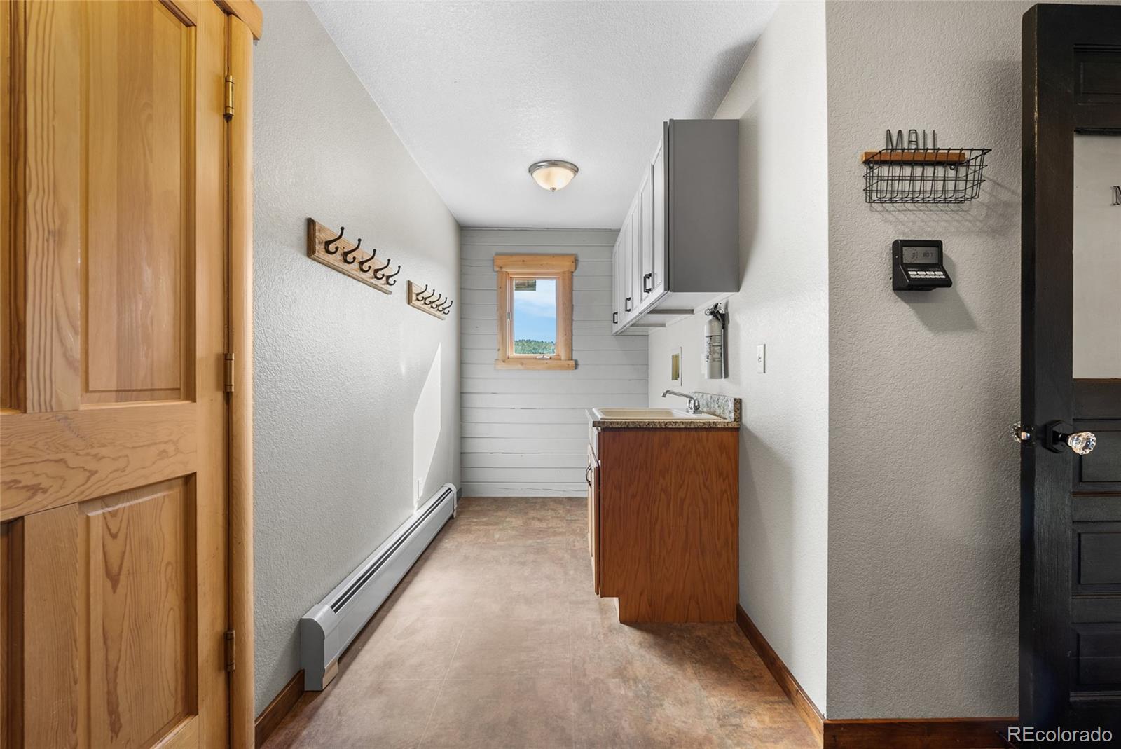685 Jesse Lane Bailey, CO 80421 - Photo 16 of 50 a en suite bathroom with a sink and mirror