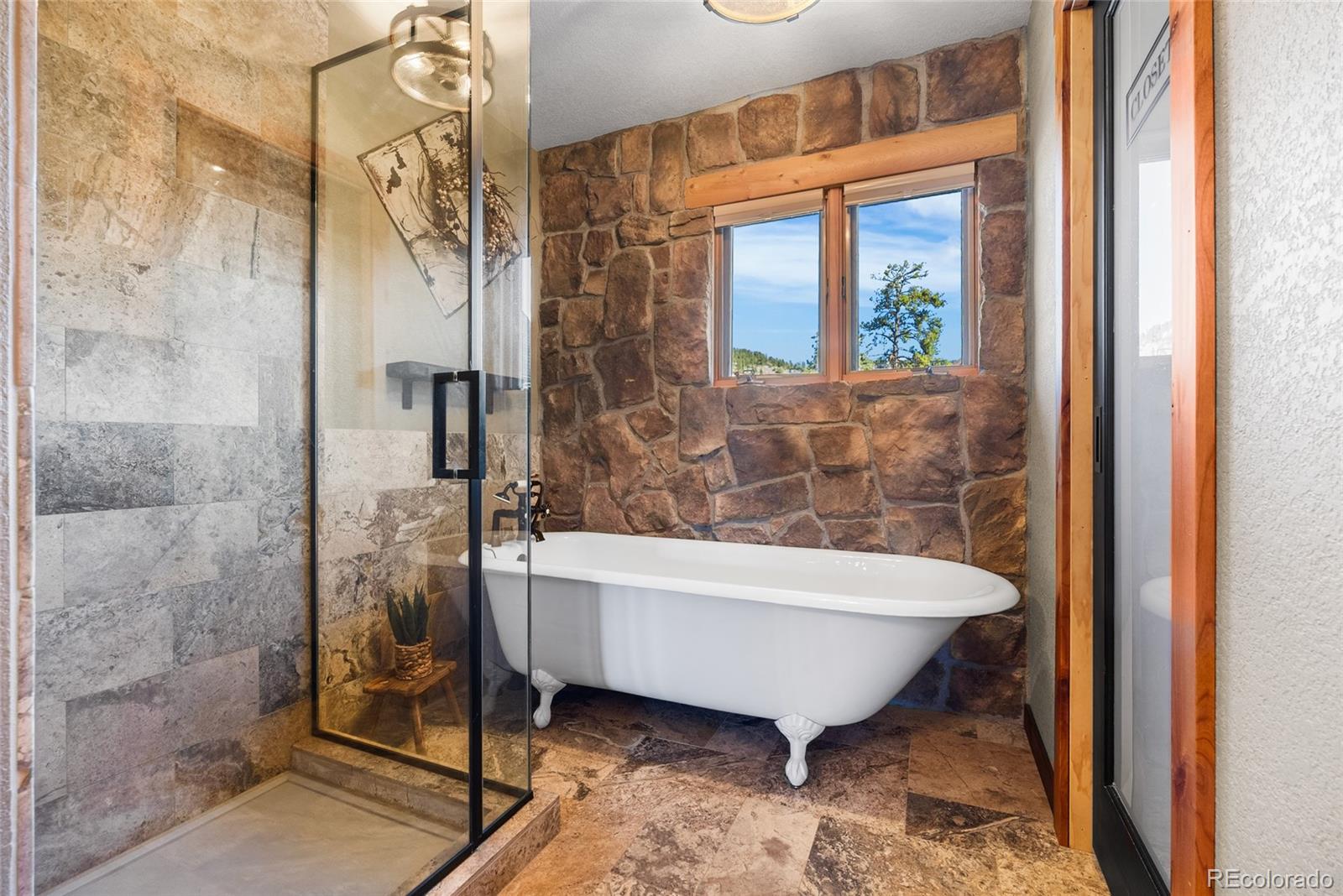 685 Jesse Lane Bailey, CO 80421 - Photo 22 of 50 a bathroom with a bathtub and shower