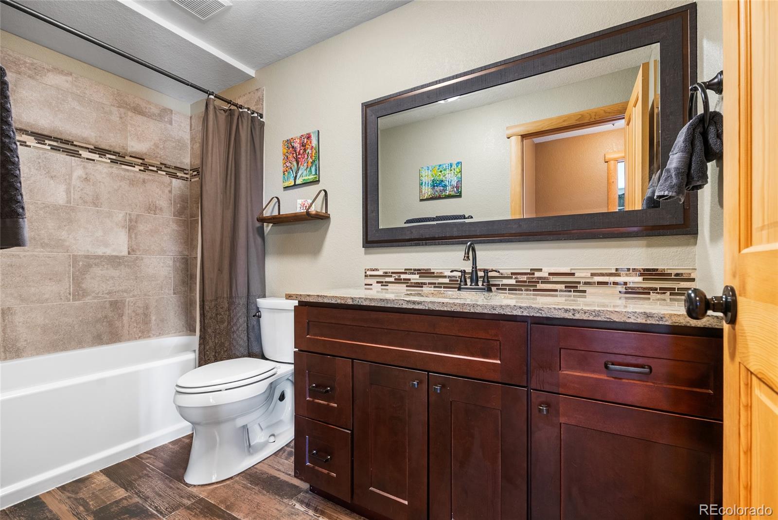 685 Jesse Lane Bailey, CO 80421 - Photo 34 of 50 a bathroom with a granite countertop sink toilet and shower