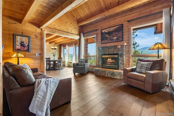 a living room with furniture a fireplace and a table