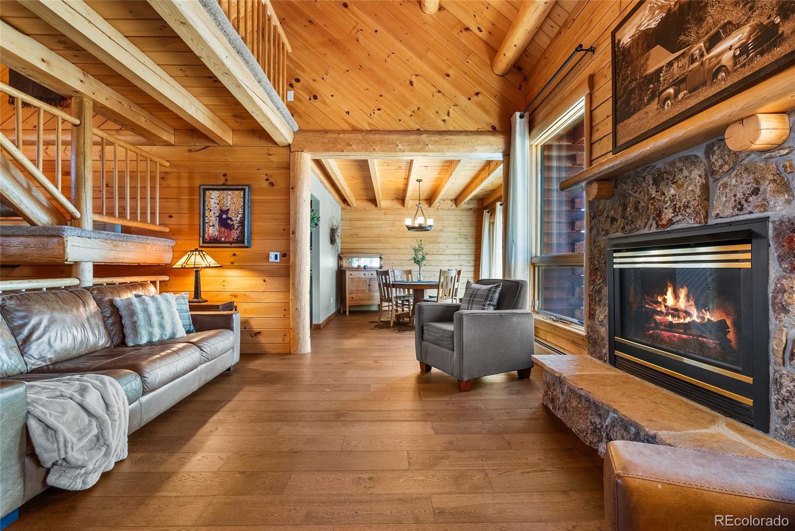 685 Jesse Lane Bailey, CO 80421 - Photo 5 of 50 a living room with furniture a fireplace and a table