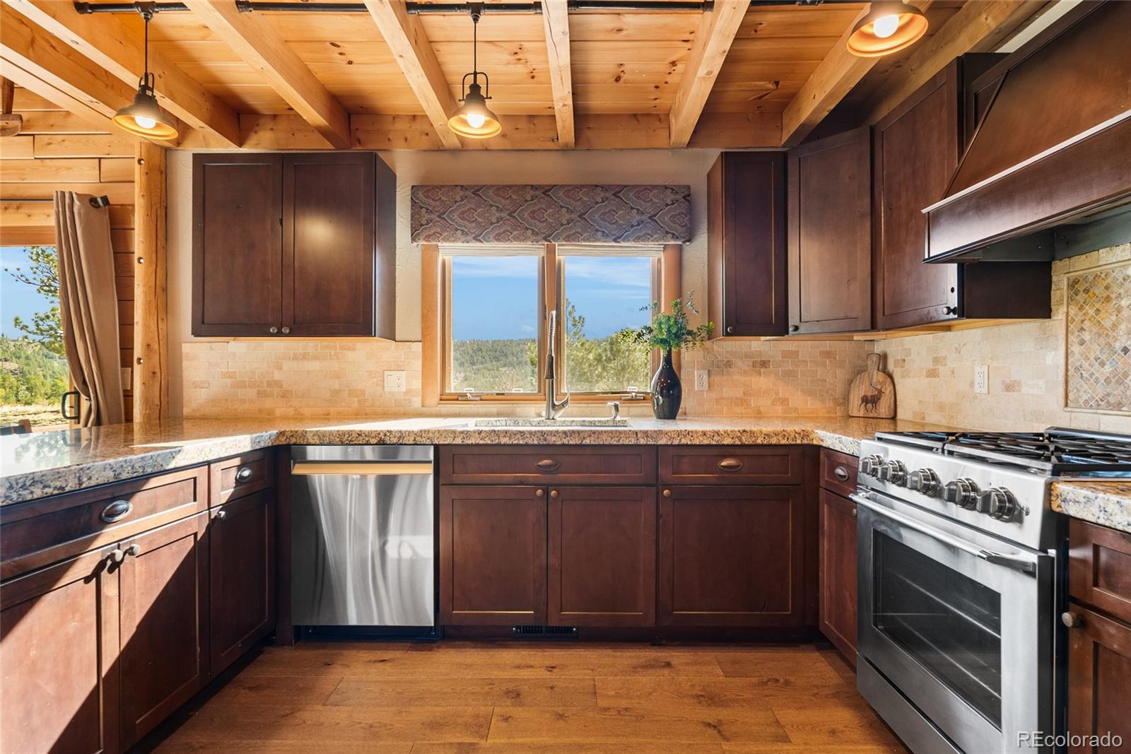 685 Jesse Lane Bailey, CO 80421 - Photo 7 of 50 a kitchen with granite countertop a sink and a stove