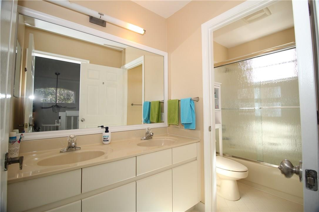 790 Chimney Rock Road Weston, FL 33327 - Photo 12 of 18 a bathroom with a toilet a sink and a large mirror