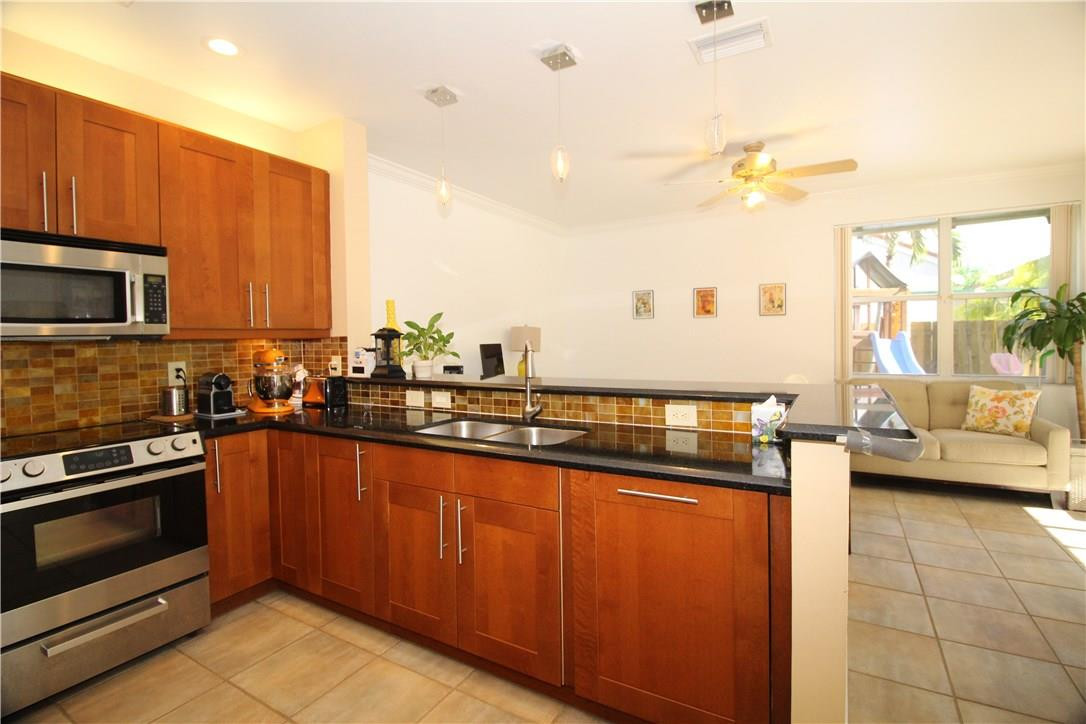 790 Chimney Rock Road Weston, FL 33327 - Photo 8 of 18 a kitchen with stainless steel appliances a stove a sink and a microwave