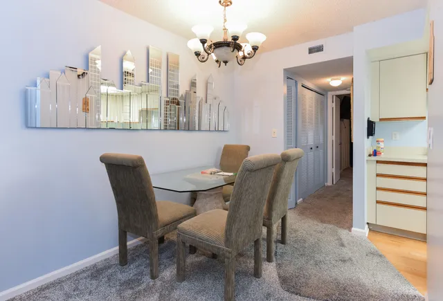 a view of a dining room with furniture and a chandelier