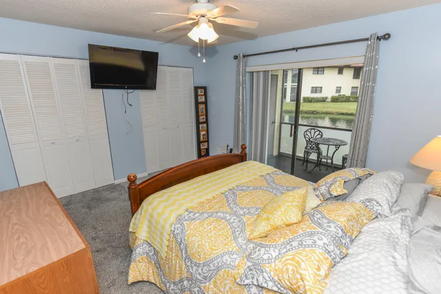 a bedroom with a bed a flat screen tv and a bed