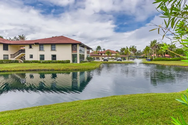 a view of a lake with a house in the background