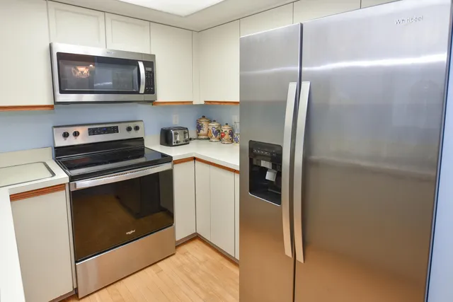 a kitchen with a refrigerator stove and microwave