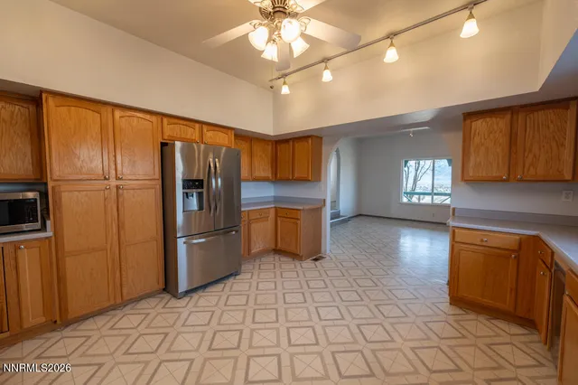 a kitchen with stainless steel appliances granite countertop a sink cabinets and window