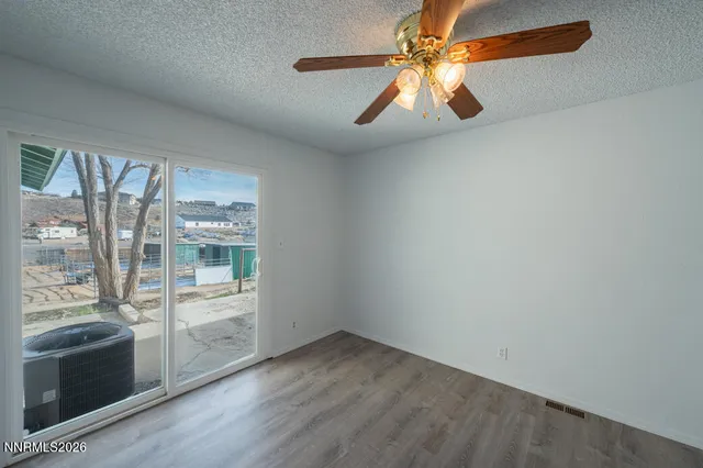 a view of a livingroom with wooden floor and a chandelier