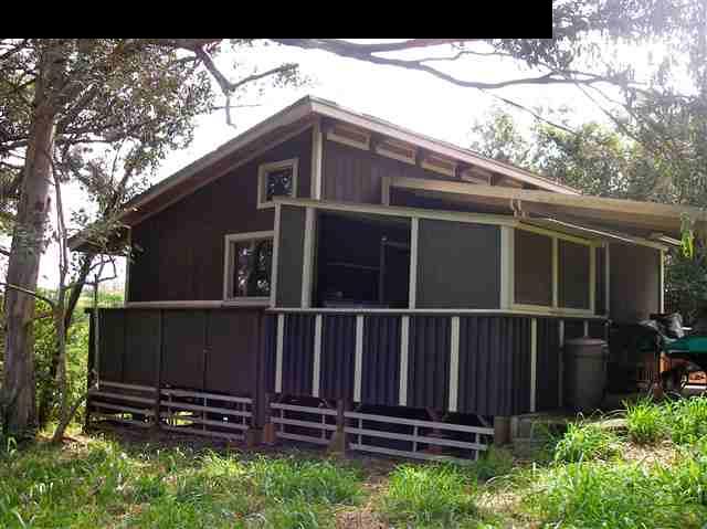 22 West Kuiaha Road Haiku, HI 96708 - Photo 1 of 23 a view of a house with a large window and wooden fence