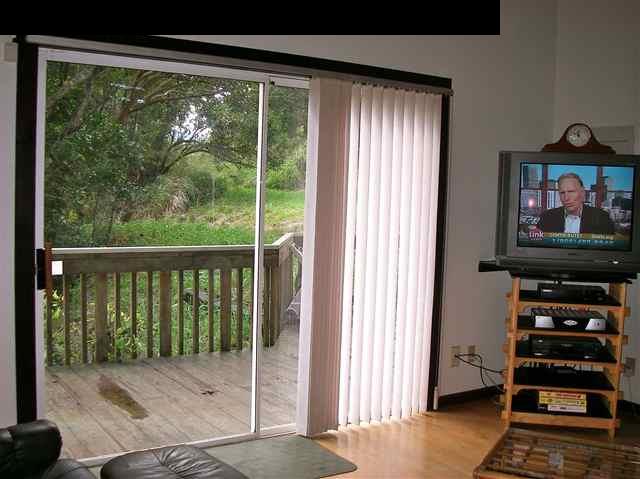22 West Kuiaha Road Haiku, HI 96708 - Photo 8 of 23 a bedroom with a bed and a flat tv screen