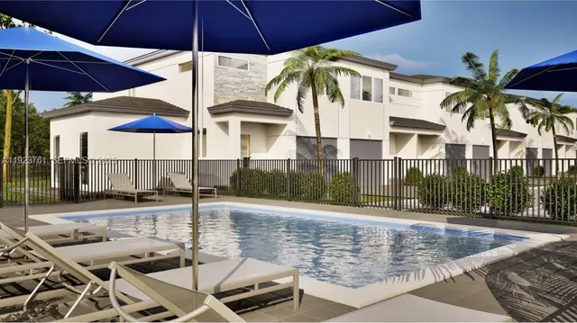 a view of a patio with a table and chairs under an umbrella