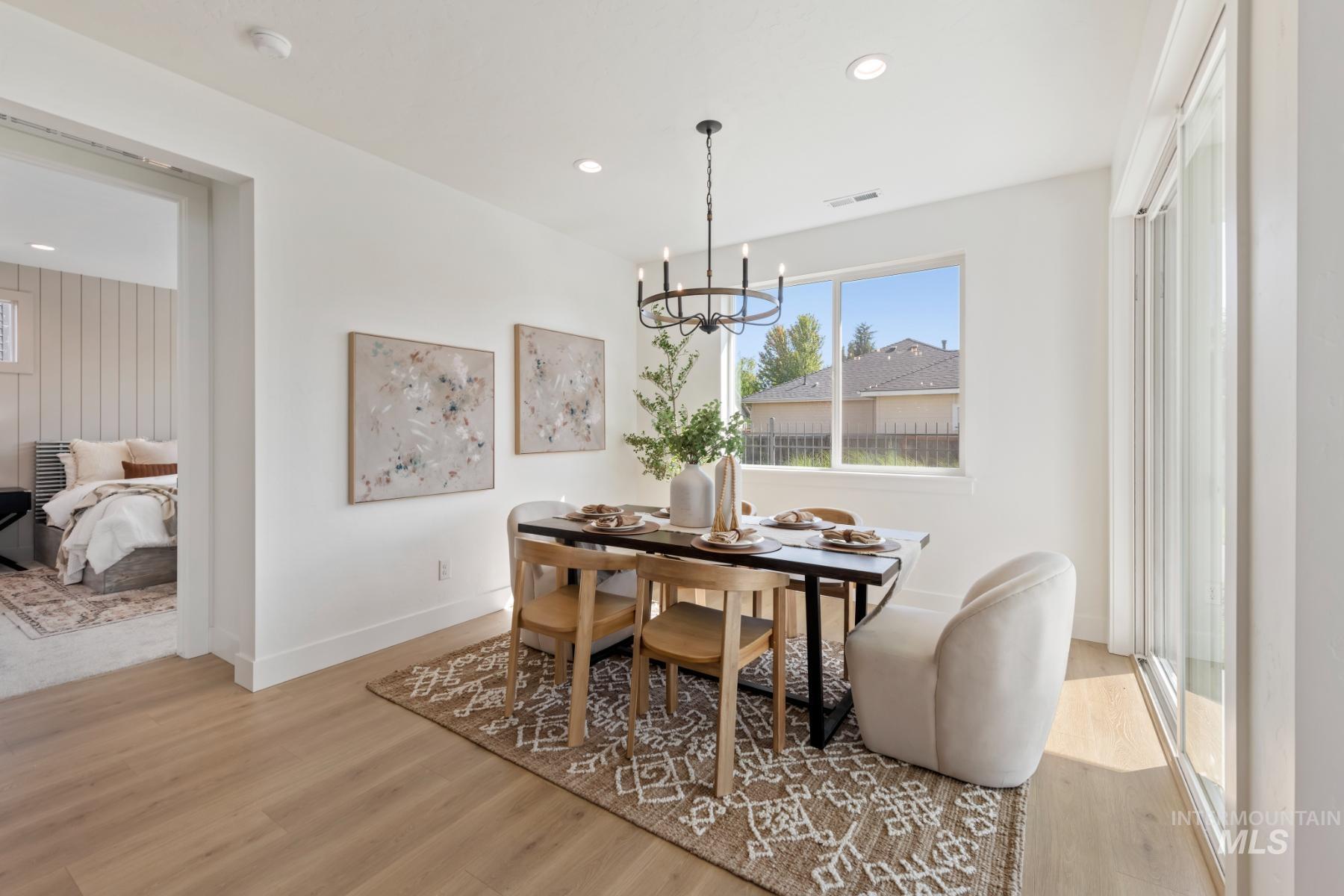 945 West Malbar Street Meridian, ID 83646 - Photo 15 of 42 Dining area with plenty of natural light, light wood-style flooring, a chandelier, and recessed lighting