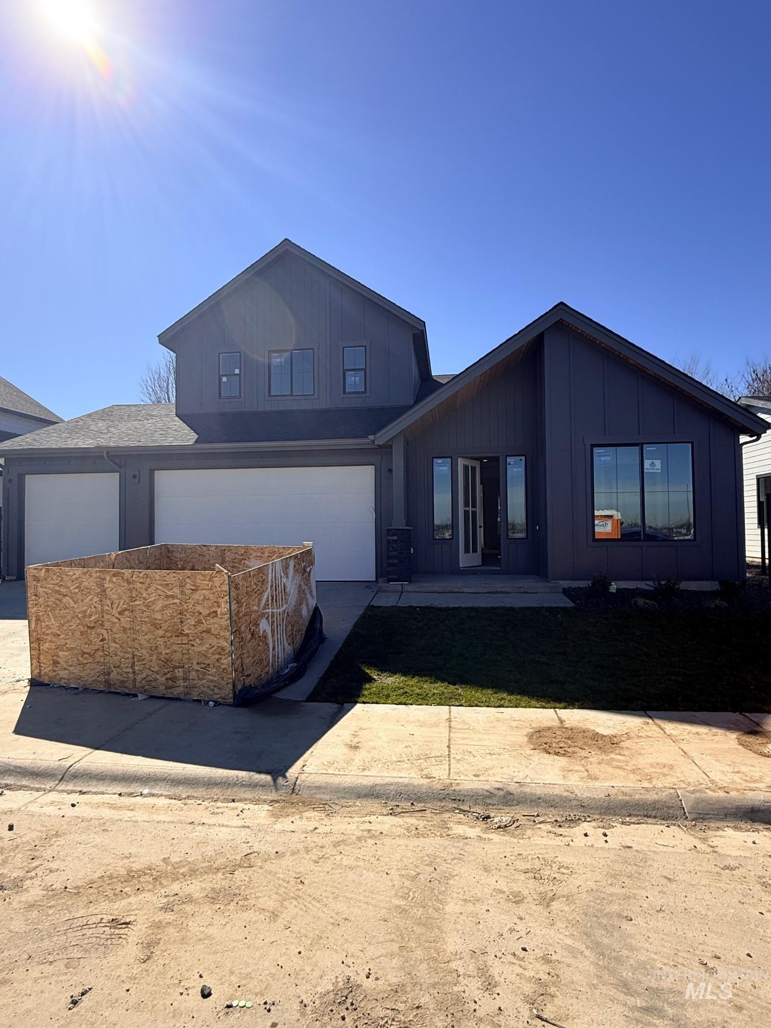 945 West Malbar Street Meridian, ID 83646 - Photo 2 of 37 View of front of house featuring concrete driveway, a garage, and board and batten siding