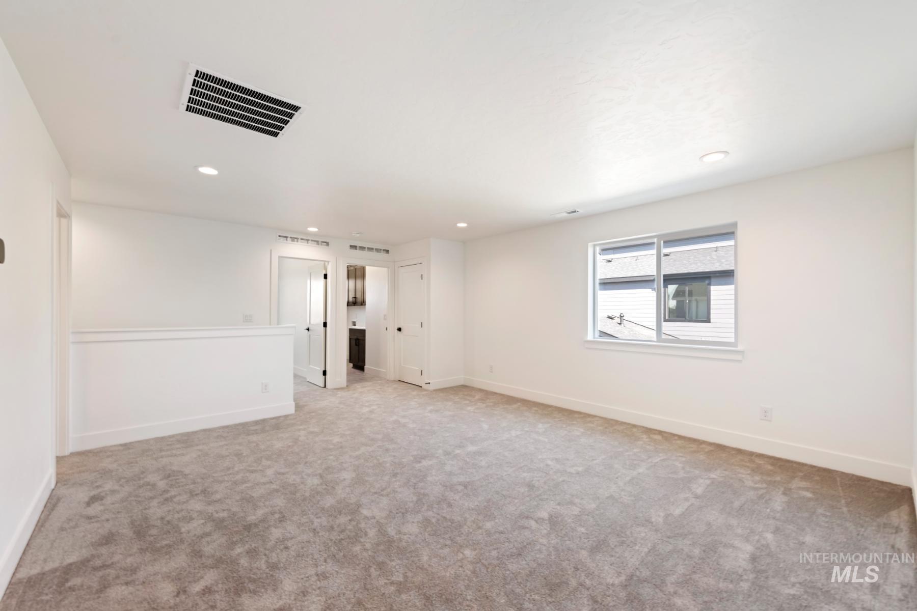 945 West Malbar Street Meridian, ID 83646 - Photo 22 of 42 Unfurnished room featuring light colored carpet and recessed lighting