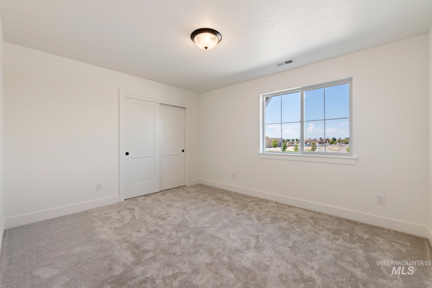 945 West Malbar Street Meridian, ID 83646 - Photo 23 of 42 Unfurnished bedroom featuring a closet and light carpet