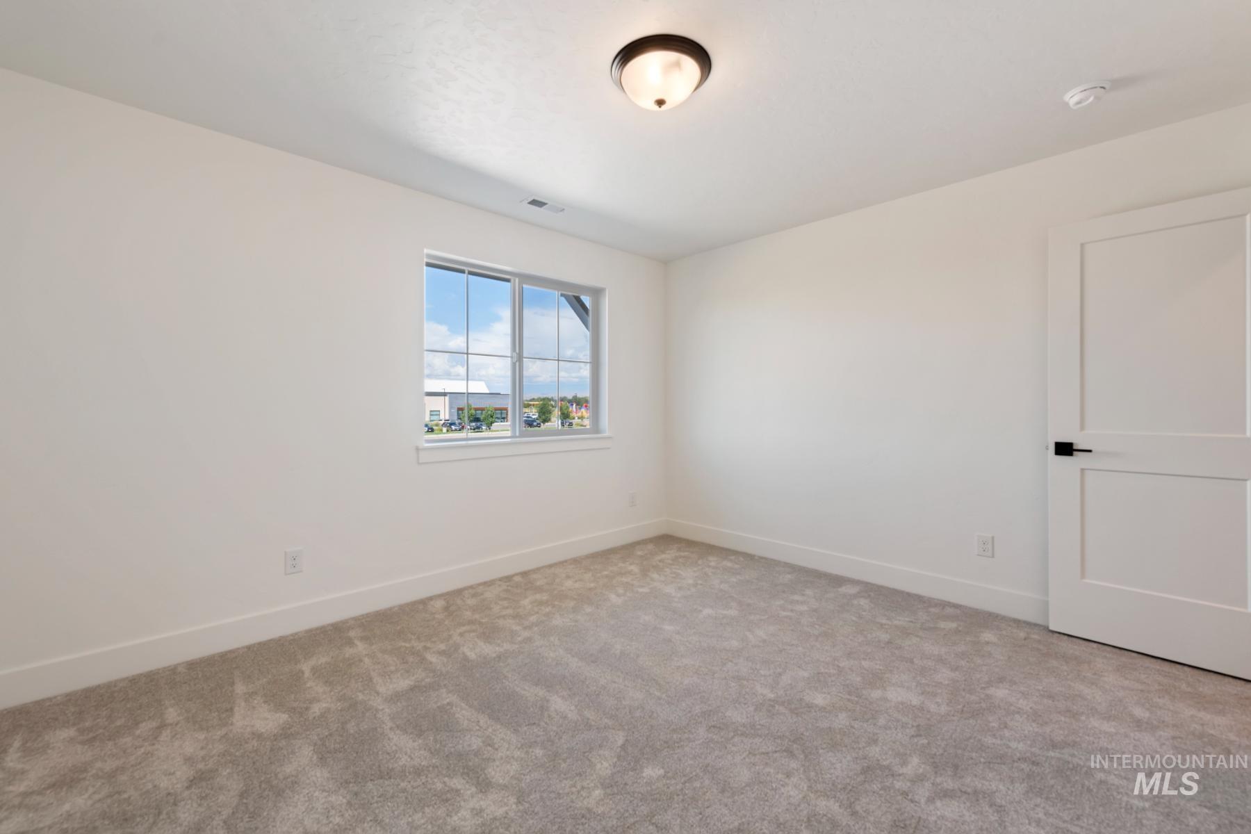945 West Malbar Street Meridian, ID 83646 - Photo 24 of 42 Spare room with baseboards and light colored carpet